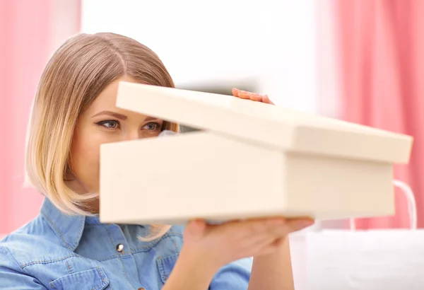 Pleasant woman opening box with shoes — стоковое фото